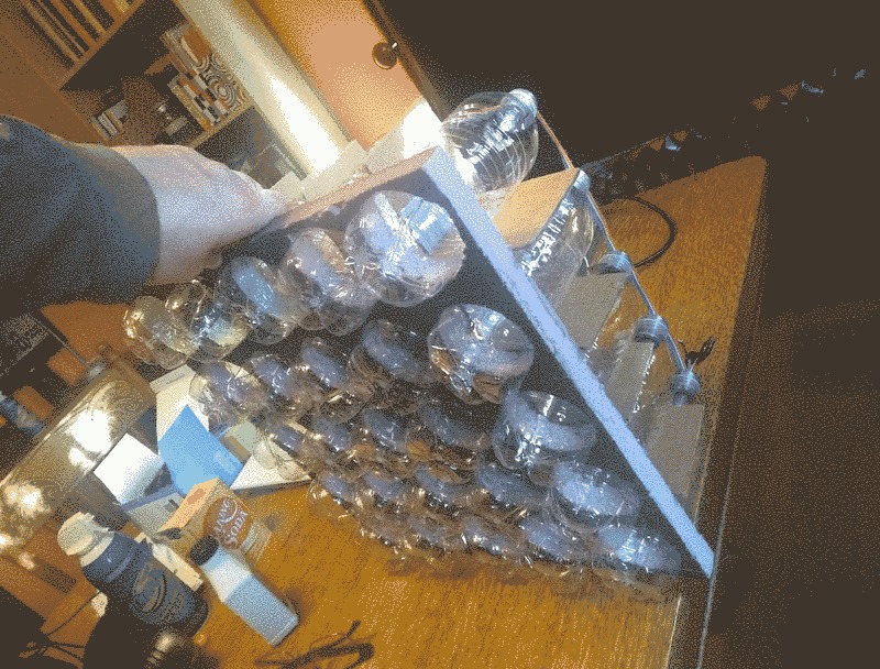 Plastic bottles held in a grid made of insulation foam.